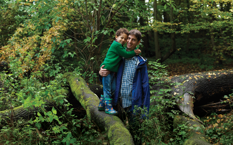 Father and son standing on a tree branch