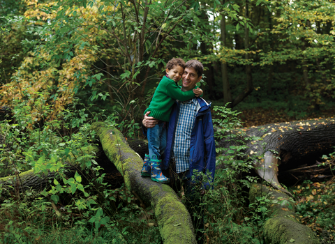 Father and son standing on a tree branch