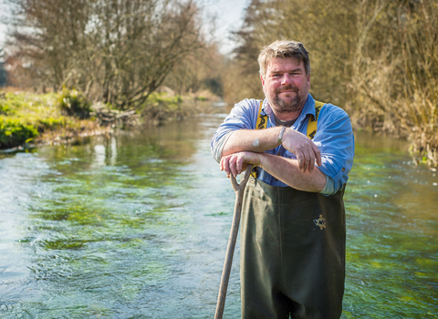 John standing in a river in his waders