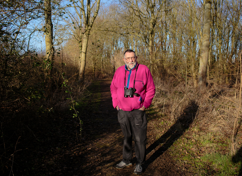 Vic stands in a woodland